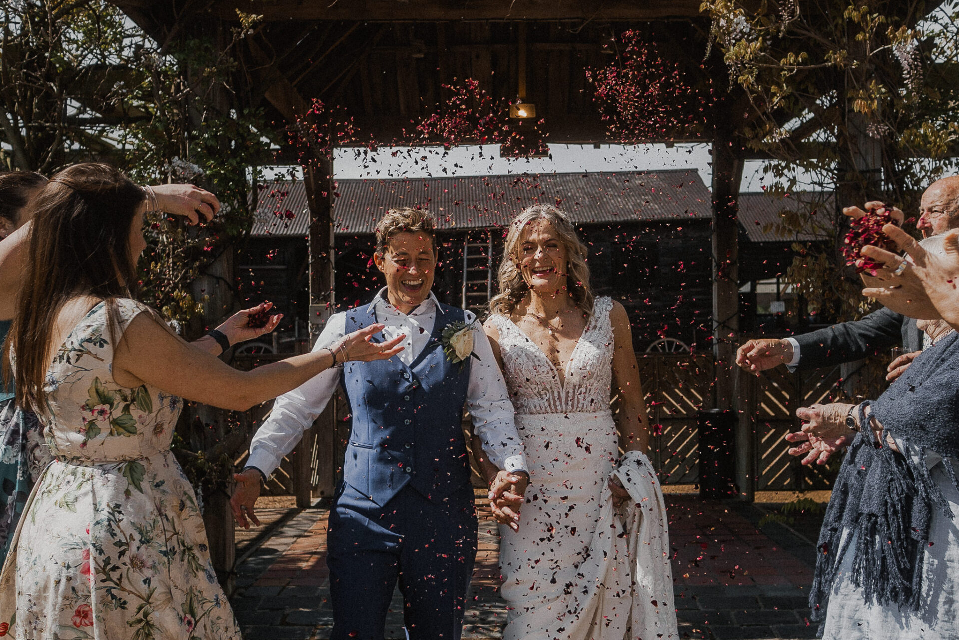 A couple celebrates their wedding with confetti-filled photographs.